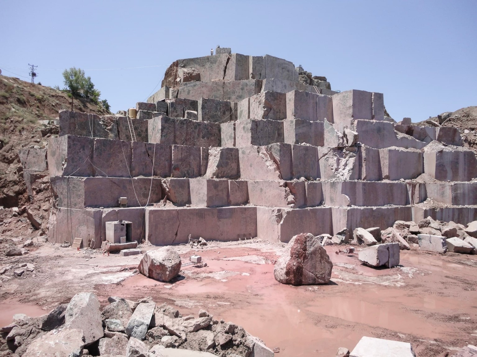 Terraced natural stone quarry with exposed rock faces